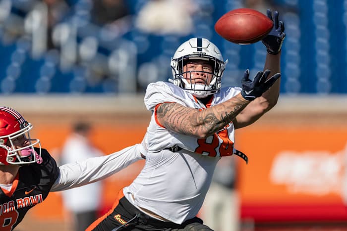 Jan 31, 2024; Mobile, AL, USA; National tight end Theo Johnson of Penn State (84) gets by National defensive back Cole Bishop of Utah (8) while tracking a pass during practice for the National team at Hancock Whitney Stadium.